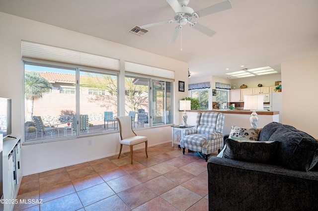 living room featuring ceiling fan and light tile patterned floors