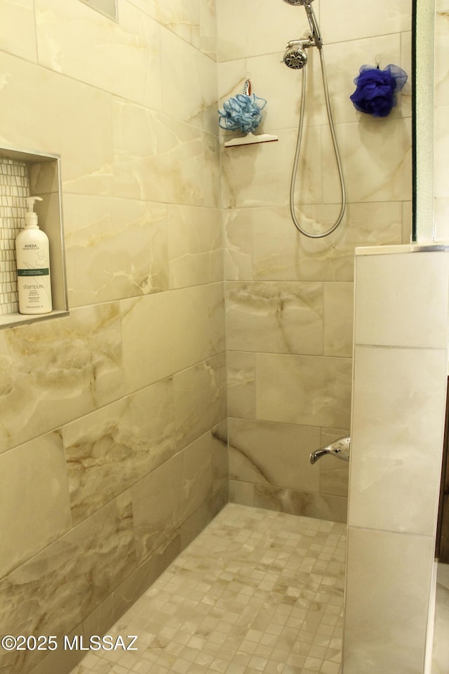 bathroom with tiled shower