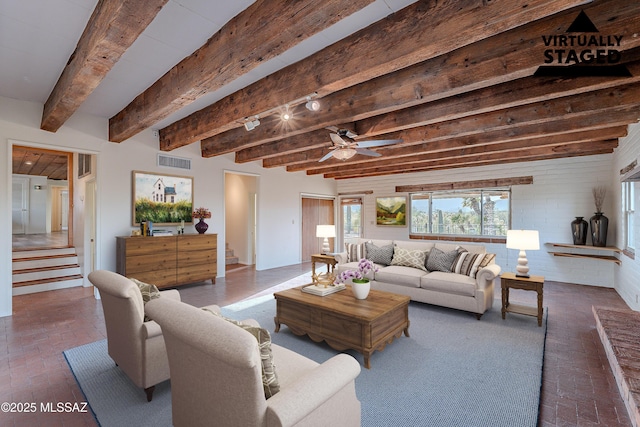 living room with brick floor, visible vents, and stairway