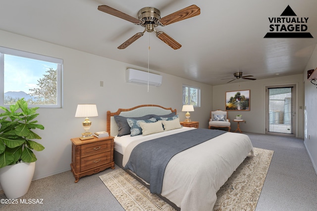 bedroom with access to exterior, multiple windows, a ceiling fan, and a wall mounted air conditioner