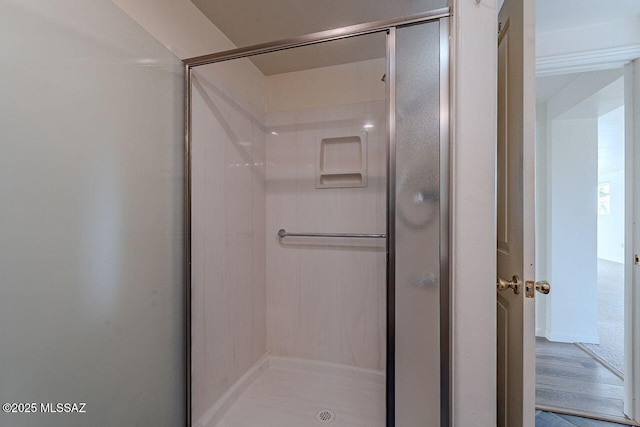 full bathroom with a shower stall and wood finished floors