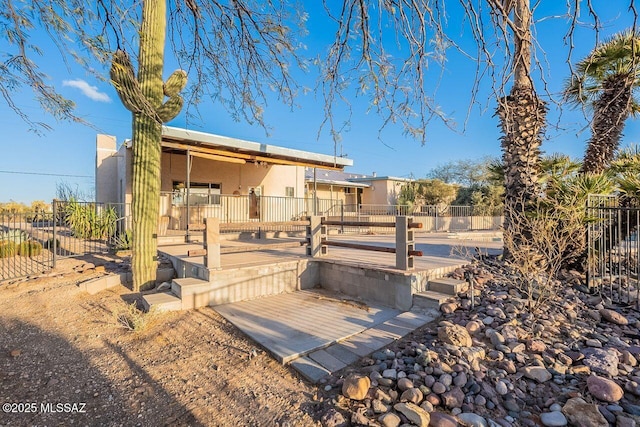 exterior space featuring fence and stucco siding