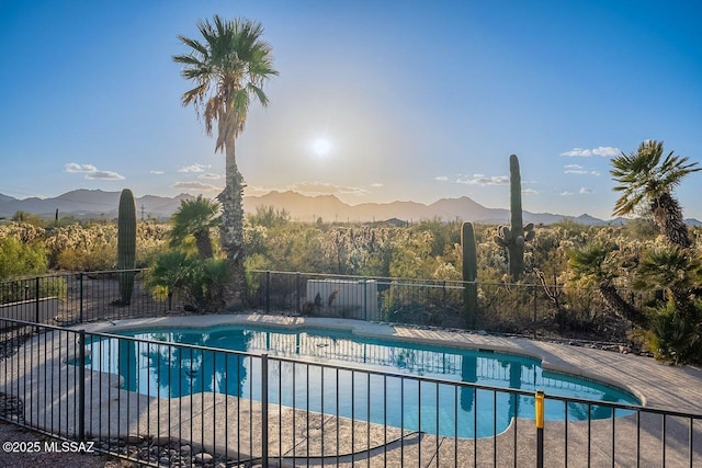 view of swimming pool with a fenced in pool, a mountain view, a patio, and fence