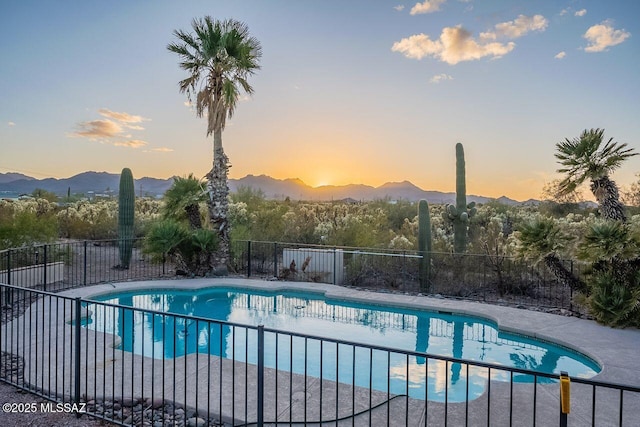 view of pool featuring a fenced in pool, a mountain view, and fence