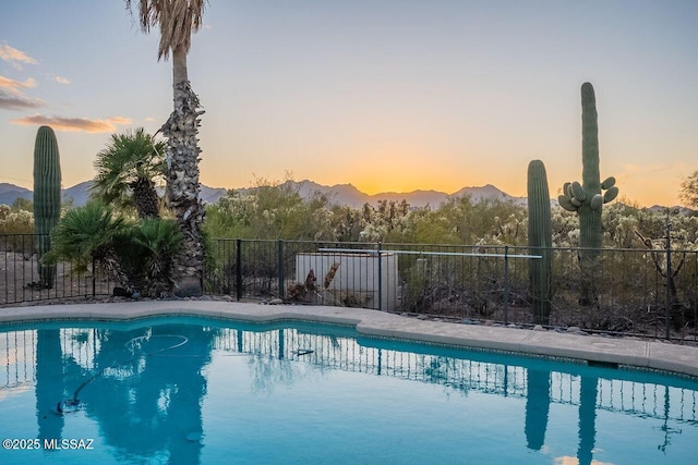 view of pool featuring fence, a mountain view, and a fenced in pool