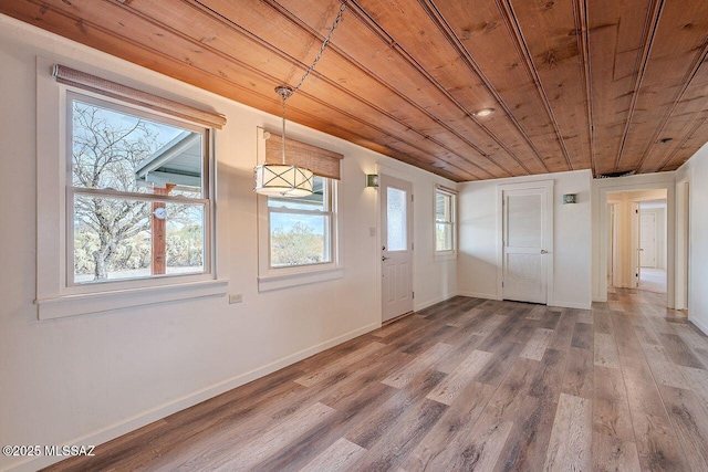 entrance foyer featuring wood ceiling, baseboards, and wood finished floors