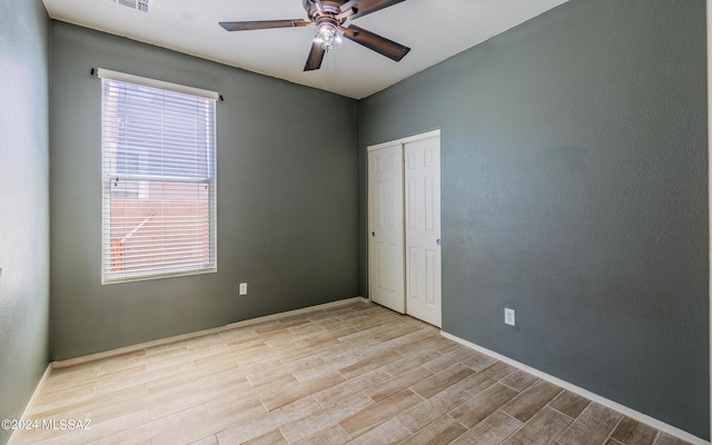 empty room featuring ceiling fan and light hardwood / wood-style flooring