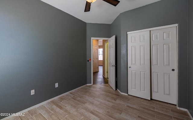 unfurnished bedroom with ceiling fan, light hardwood / wood-style flooring, and a closet