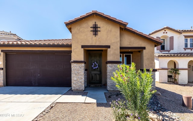 mediterranean / spanish-style home with a garage