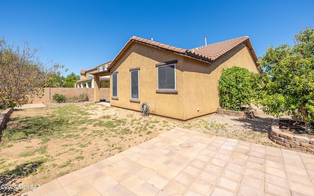 back of house with a patio