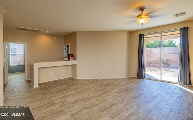 unfurnished living room with ceiling fan and light hardwood / wood-style floors