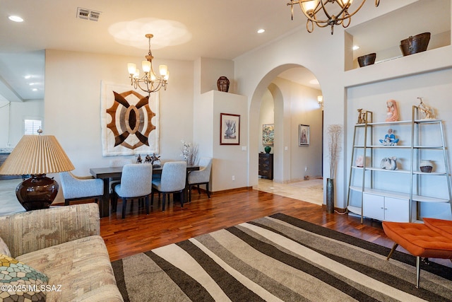 living room featuring dark hardwood / wood-style flooring and an inviting chandelier