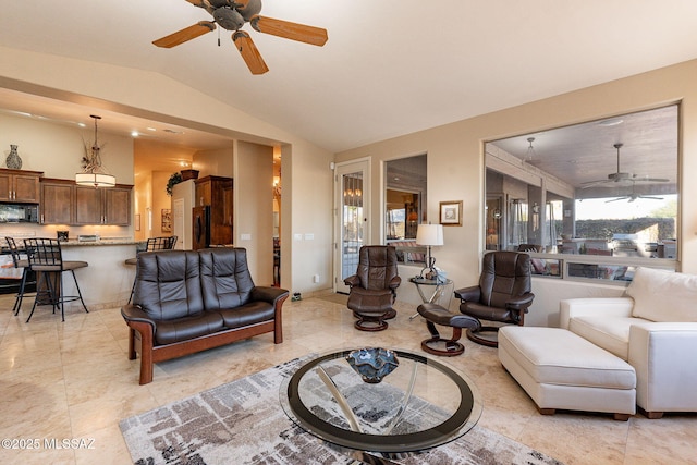 living room with ceiling fan and lofted ceiling