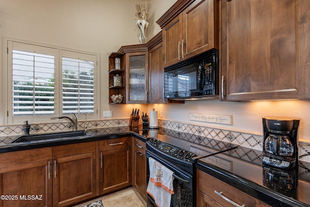 kitchen featuring sink, light tile patterned floors, and black appliances