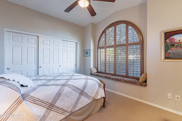 bedroom with ceiling fan, lofted ceiling, carpet floors, and a closet