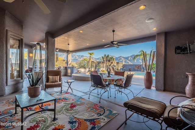 view of patio / terrace featuring ceiling fan, a mountain view, and an outdoor kitchen