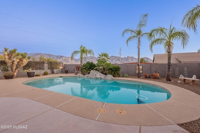 view of swimming pool with a mountain view