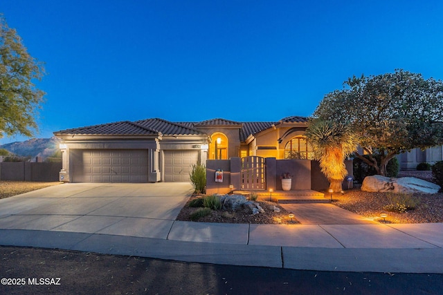 mediterranean / spanish-style home with a garage