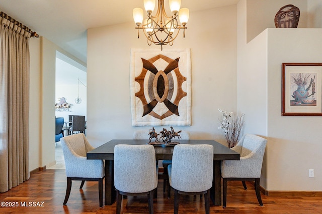 dining space featuring hardwood / wood-style floors and a notable chandelier