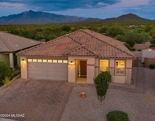 mediterranean / spanish home with a mountain view and a garage