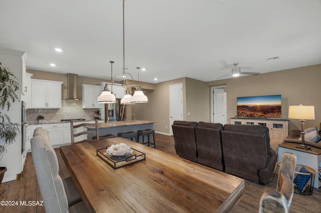 dining room with ceiling fan, dark wood-type flooring, and sink