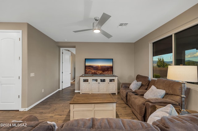 living room featuring ceiling fan and hardwood / wood-style flooring