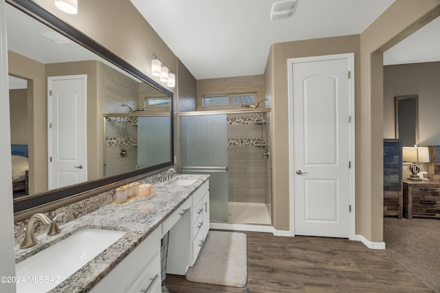 bathroom with vanity, an enclosed shower, and wood-type flooring