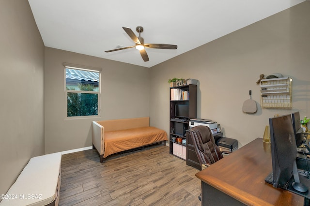 home office featuring hardwood / wood-style floors and ceiling fan