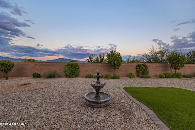 view of yard at dusk