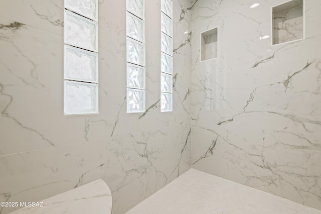 bathroom featuring tiled shower