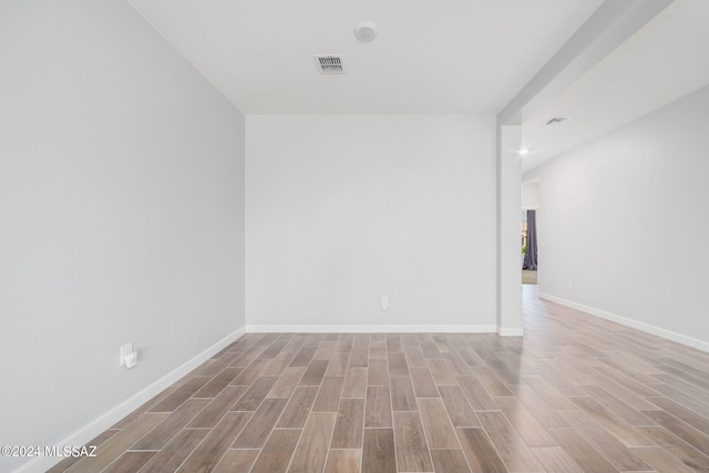 unfurnished room with wood-type flooring