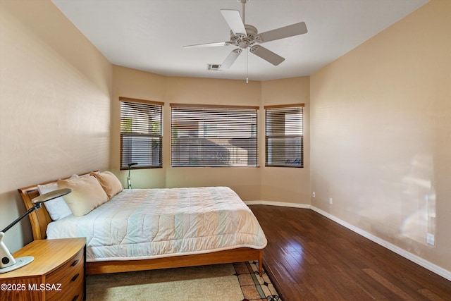 bedroom with dark hardwood / wood-style flooring and ceiling fan