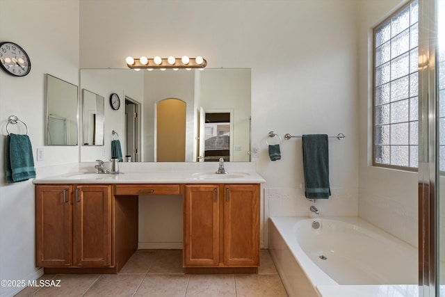 bathroom featuring a bath, vanity, a wealth of natural light, and tile patterned floors