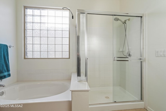 bathroom featuring separate shower and tub and a wealth of natural light