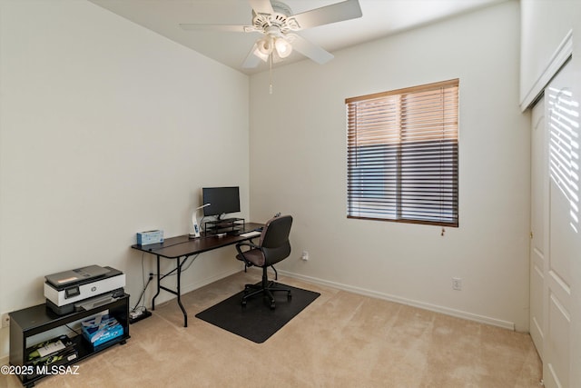 carpeted office space with ceiling fan