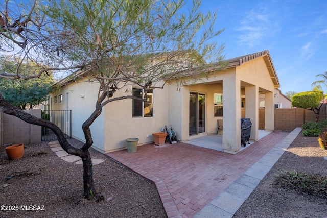 back of property with a patio