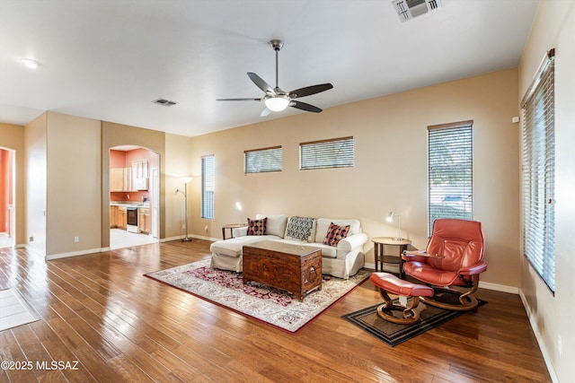 living room with hardwood / wood-style floors and ceiling fan