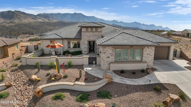 view of front of home with a garage and a mountain view