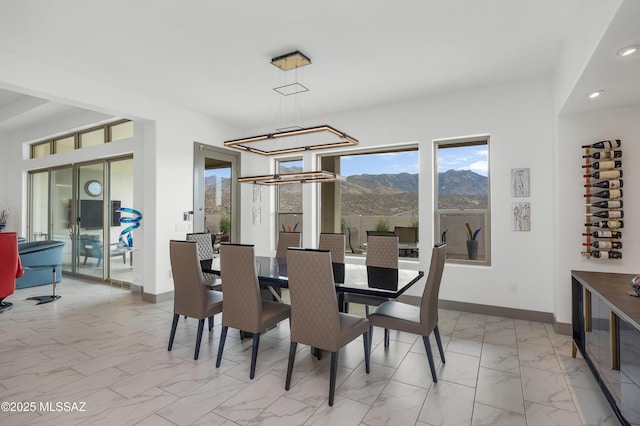 dining room featuring an inviting chandelier and a mountain view