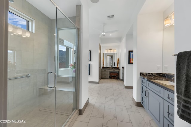 bathroom with ceiling fan, vanity, and a shower with shower door