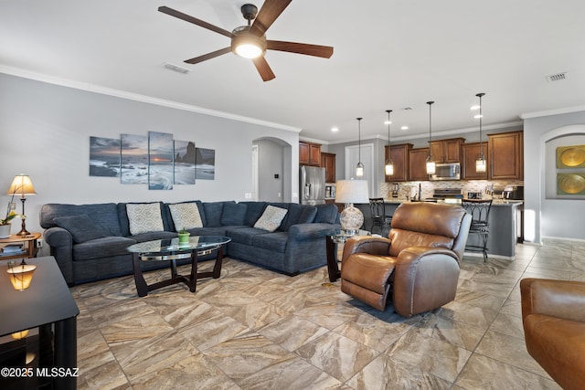 living room with crown molding and ceiling fan