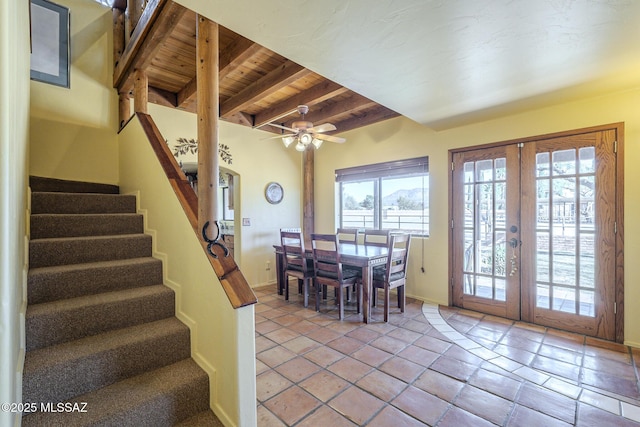 dining area with ceiling fan, french doors, wooden ceiling, and beamed ceiling