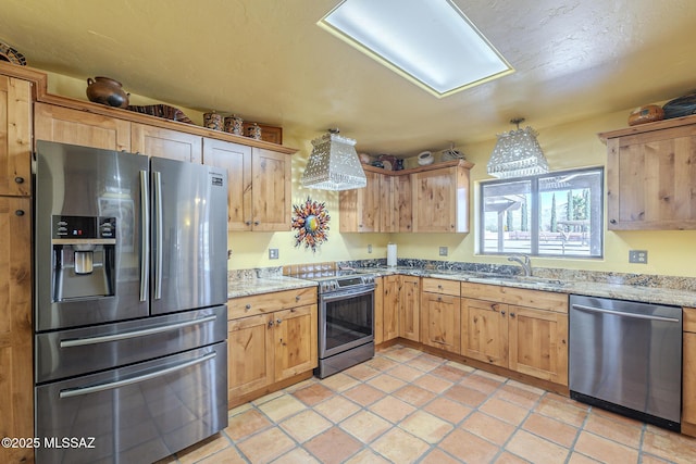 kitchen featuring stainless steel appliances, sink, exhaust hood, and light stone countertops