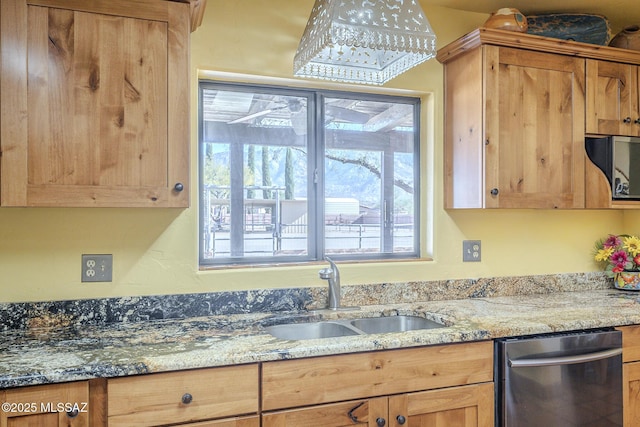 kitchen with sink, dishwasher, and light stone countertops