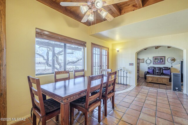 dining room with ceiling fan, wood ceiling, french doors, and beamed ceiling