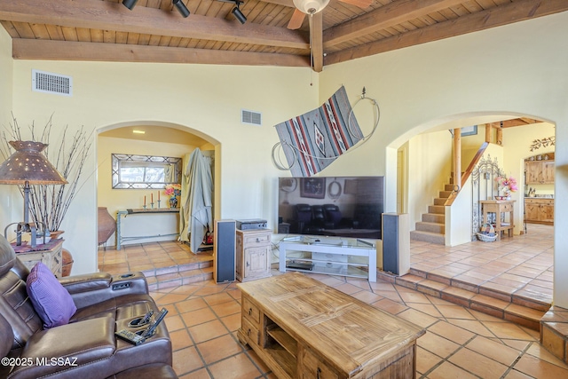 living room with ceiling fan, light tile patterned floors, wooden ceiling, and vaulted ceiling with beams