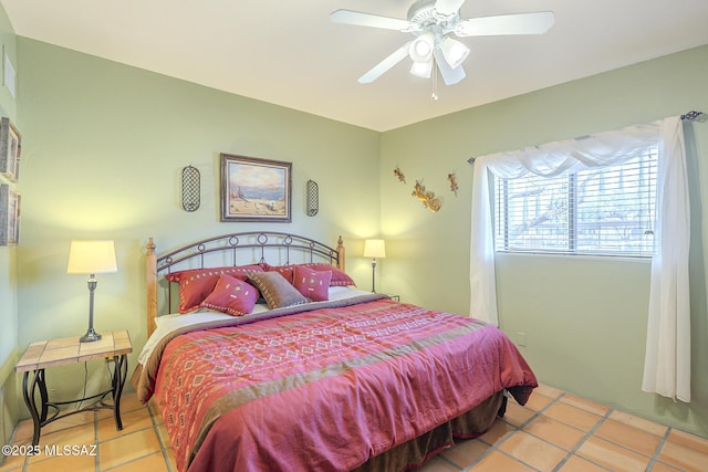 tiled bedroom featuring ceiling fan