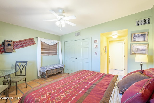 tiled bedroom featuring a closet and ceiling fan