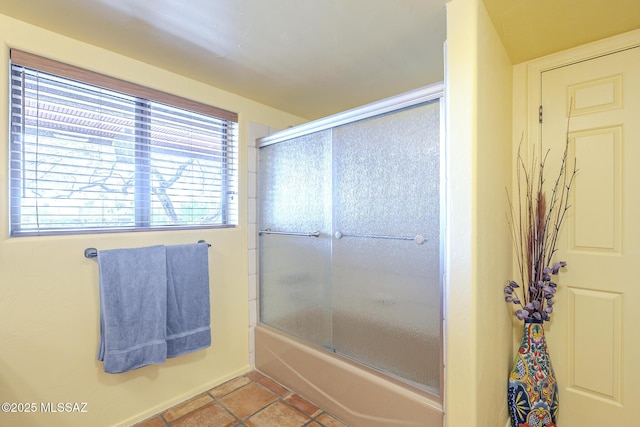 bathroom featuring shower / bath combination with glass door and tile patterned floors