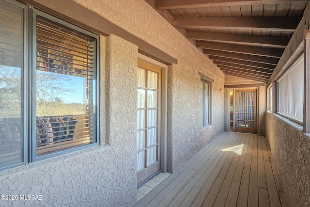 interior space featuring a wealth of natural light, vaulted ceiling with beams, wood ceiling, and hardwood / wood-style floors